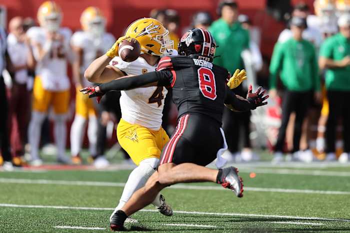 Nov 4, 2023; Salt Lake City, Utah, USA; Arizona State Sun Devils running back Cameron Skattebo (4) is pressured by Utah Utes safety Cole Bishop (8) in the third quarter at Rice-Eccles Stadium. Mandatory Credit: Rob Gray-USA TODAY Sports  
